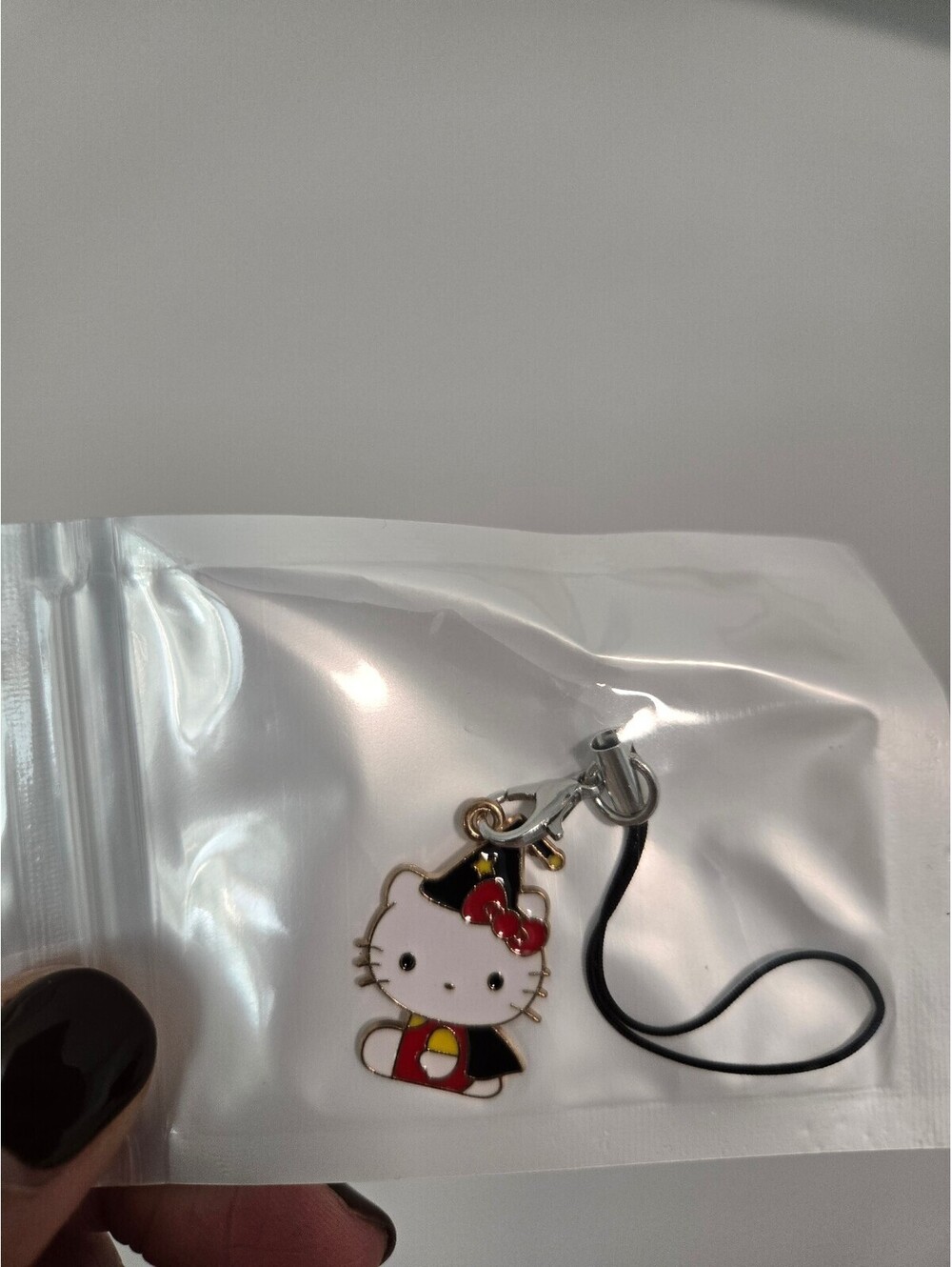 Hello Kitty candy corn enamel phone charm
